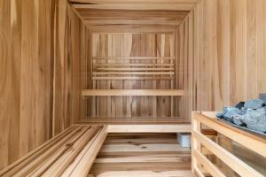 a sauna with wooden walls and wooden shelves at Stylish 1BR Condo with Private Pool & Balcony in Tulum