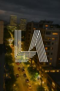 a lit up letter k in a city at night at LA Luxury Rooftop in Tirana