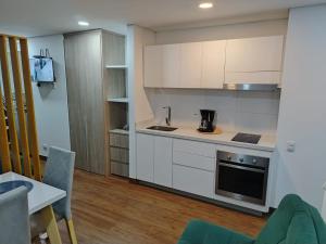 a kitchen with white cabinets and a stove top oven at Premium Tranquility in the International Center in Bogotá