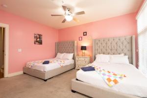 two beds in a bedroom with pink walls at Pink Experience - West End Broadway & Restaurants in Nashville