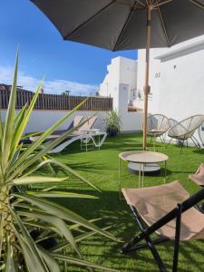 a patio with a table and chairs and an umbrella at Cala Sol - few steps from the beach in La Cala de Mijas