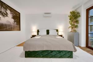a bedroom with a large bed with two lamps at Design Apartments Schloss Burg Solingen - BRIGHT Collection in Solingen