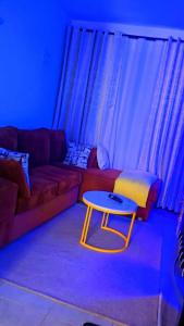 a living room with a couch and a table at Tsavo in Nairobi