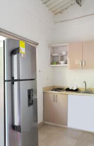 a kitchen with a stainless steel refrigerator at Hotel Villa Ivel in Turbaco +22 photos