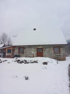 una casa coperta da neve con tetto ricoperto di neve di Stone House 1866 