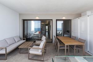 a living room with a couch and a table and chairs at Bayview Hills Suite by Casasol in Torrox