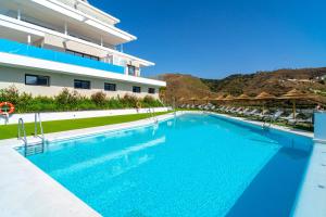 a swimming pool in front of a building at Bayview Hills Suite by Casasol in Torrox