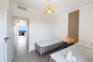 a bedroom with two beds and a view of the ocean at Bayview Hills Suite by Casasol in Torrox +59 photos