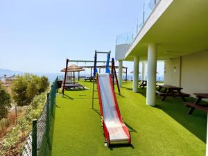 a playground with a slide on the side of a building at Bayview Hills Suite by Casasol in Torrox