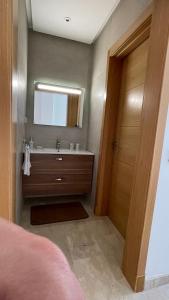 a bathroom with a sink and a mirror at Serenity - Appart Piscine - 4-5p in Agadir +27 photos