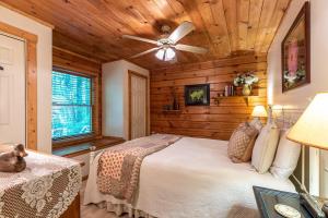 Un dormitorio con una cama y un ventilador de techo. en Trillium, en Banner Elk