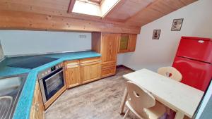 a kitchen with a red refrigerator and a table at Chiemsee-Ferienhaus Schlegel in Breitbrunn am Chiemsee