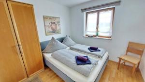 a bedroom with a bed with two pillows on it at Chiemsee-Ferienhaus Schlegel in Breitbrunn am Chiemsee