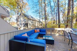a blue couch on a deck with a table and chairs at Sea Colony - 2306 Round Robin Way in Sea Colony