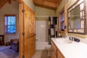 a bathroom with a sink and a toilet and a mirror at Bear Creek in Sugar Grove +29 photos