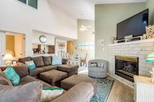 a living room with a couch and a fireplace at Sea Colony - 53021 Lakeshore Dr in Wilgus Subdivision