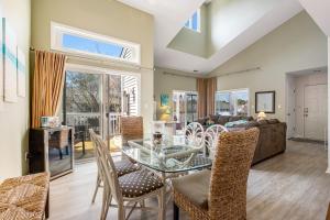 a living room with a glass table and chairs at Sea Colony - 53021 Lakeshore Dr in Wilgus Subdivision