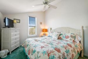 a bedroom with a bed and a ceiling fan at Sea Colony - 53021 Lakeshore Dr in Wilgus Subdivision