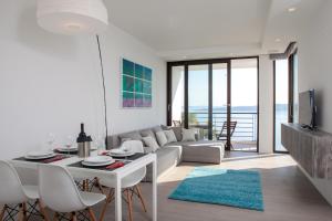 a living room with a couch and a table and chairs at Soho Apartments Brela in Brela