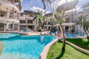 a swimming pool in front of a building at Hermosa Wave B2 in Pochotal