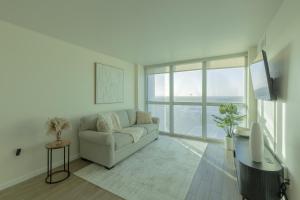 a living room with a couch and a large window at The Luxury spot 2 min to DOWNTOWN 5 min to The beach in Fort Myers