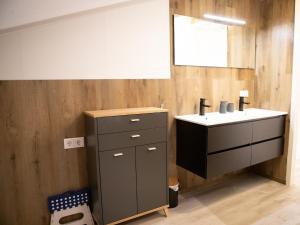 a bathroom with a sink and a mirror at Tiny Home in Oirschot next to forest in Haghorst +26 photos