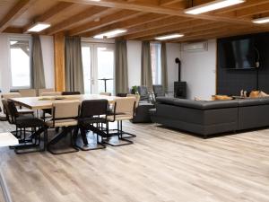 a conference room with a table and a couch at Tiny Home in Oirschot next to forest in Haghorst