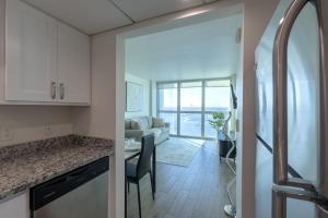 a kitchen and living room with a couch and a table at The Luxury spot 2 min to DOWNTOWN 5 min to The beach in Fort Myers