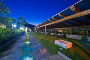 an outdoor pavilion with a stone walkway at night at Gli Dei gemelli in Agerola