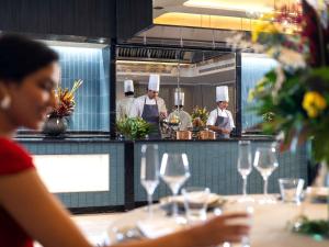 a group of chefs in a kitchen with wine glasses at Pullman Chennai Anna Salai - Premium Brand By Accor in Chennai