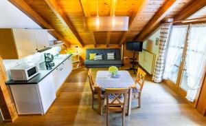 a kitchen and dining room with a table and a couch at Ferienwohnungen Dananic in Anger