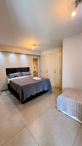 a bedroom with a large bed and a bedskirts at Unidade Autonoma 609 em Villa Del Sol in Rio de Janeiro