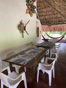 a wooden table and chairs in a room at La Coralina azul in San Bernardo del Viento +38 photos