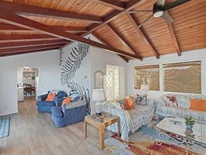 a living room with two blue couches and a table at Sq Seaside Cottage in Sequim