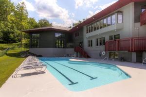 a large swimming pool in front of a building at Sunrise - W Glade J-1 in Killington