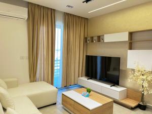 a living room with a couch and a tv at Snow light 2BDR , Madinaty in Madinaty
