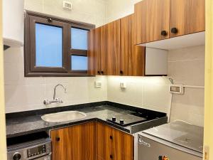 a kitchen with a sink and a counter top at Snow light 2BDR , Madinaty in Madinaty