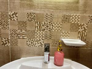 a bathroom with a sink with a pink soap dispenser at Snow light 2BDR , Madinaty in Madinaty +24 photos