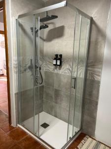 a shower with a glass door in a room at La villa de Leo y Lola in Frómista +45 photos