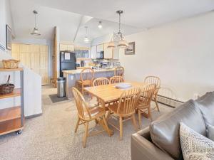 a kitchen and dining room with a table and chairs at Woods Village 10 in Killington
