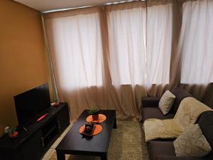 a living room with a couch and a coffee table at The Orange Corner II in Johannesburg