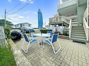 a patio with a table and chairs and an umbrella at Seascapes in Wells