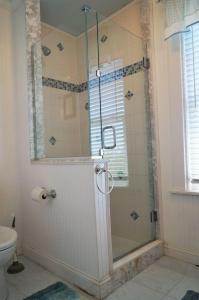 a shower with a glass door in a bathroom at Short Sands View in York Beach +24 photos