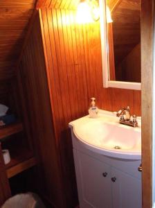 a bathroom with a sink and a mirror at Cozy Cottage by the Sea in York