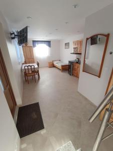 a living room with a table and a dining room at Willa Gorce in Ostrowsko