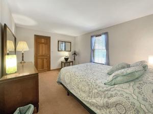 a bedroom with a bed and a dresser and a window at High View at Short Sands in York