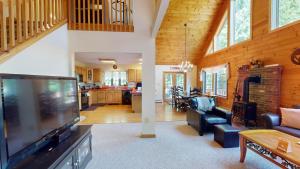 a living room with a tv and a living room at Beechwood Home in Mendon