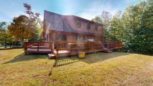 a large wooden house with a large deck at Beechwood Home in Mendon