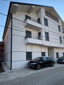 a black car parked in front of a building at The Green Nest in Surčin