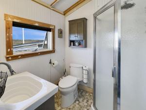 a bathroom with a toilet and a sink and a shower at Sea Esta in Wells +26 photos